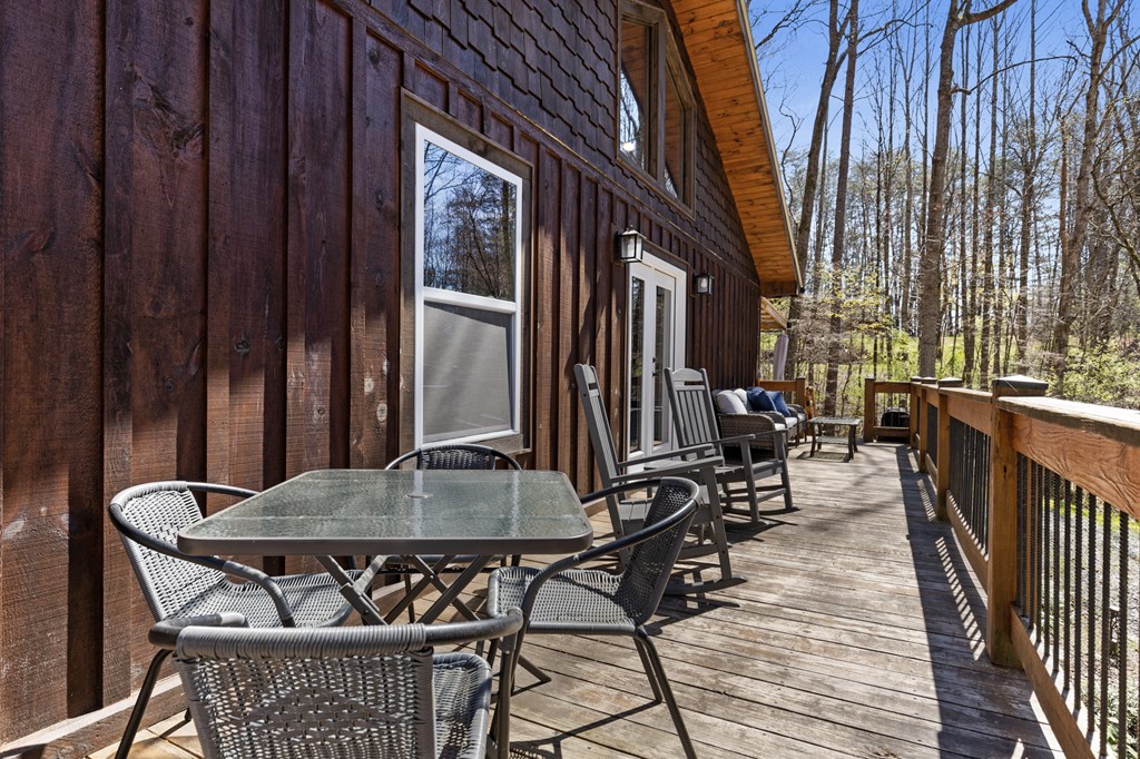 941 Hidden Valley Drive Morganton, GA 30560 - Photo 30 of 35 a view of a patio with table and chairs with wooden floor and fence