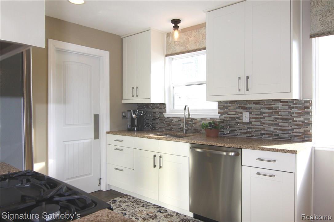 130 North Helen Avenue Rochester, MI 48307 - Photo 15 of 34 Bright Cheerful kitchen with quartz counter tops, stainless steel appliances, all soft touch drawers, built in organizers for lots of storage.