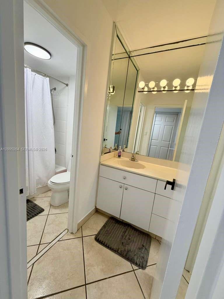 100 Lincoln Road, Unit 731 Miami Beach, FL 33139 - Photo 10 of 12 a bathroom with a double vanity sink and a mirror