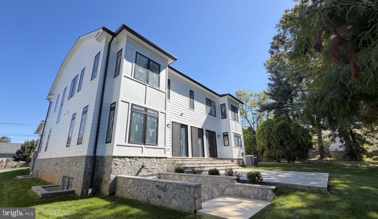 7604 Hemlock Street Bethesda, MD 20817 - Photo 2 of 5 a view of a building with a yard