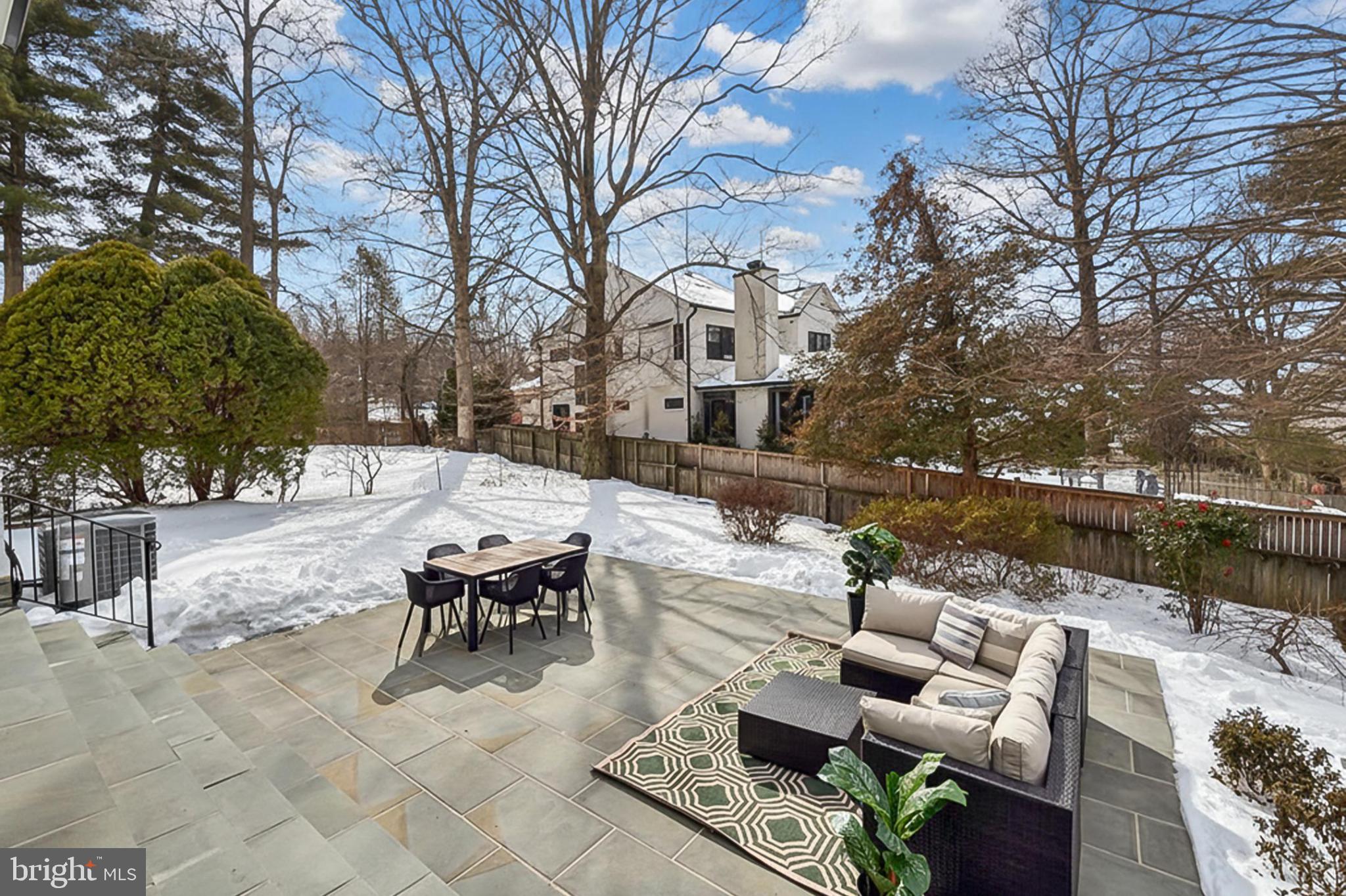 7604 Hemlock Street Bethesda, MD 20817 - Photo 78 of 85 a view of a patio with couches and a table and chairs with wooden fence and large trees
