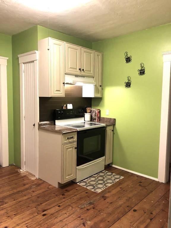5 Pomona Road Worcester, MA 01602 - Photo 8 of 25 a kitchen with a refrigerator and a stove top oven