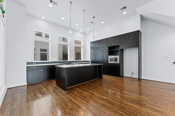 a kitchen with a sink and wooden floor