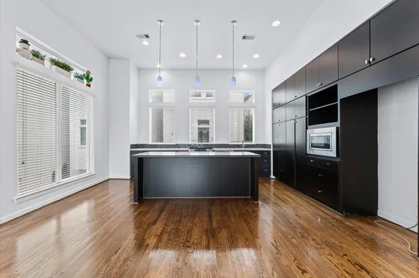 a kitchen with stainless steel appliances granite countertop a refrigerator a sink and a wooden cabinets