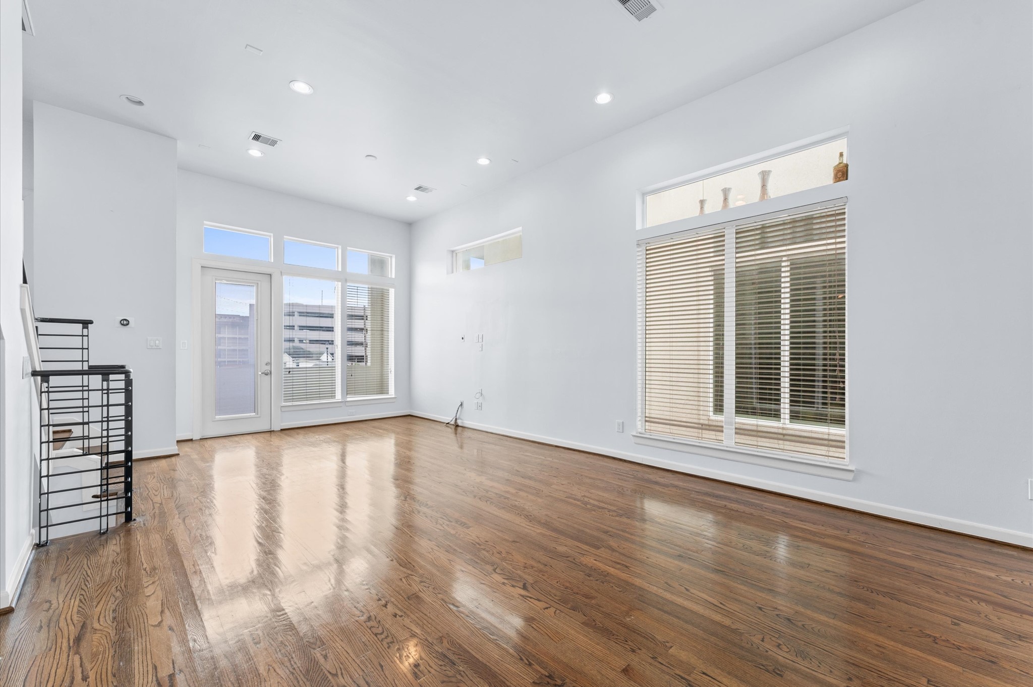 120 Pierce Street Houston, TX 77002 - Photo 19 of 45 a view of an empty room with wooden floor and a window