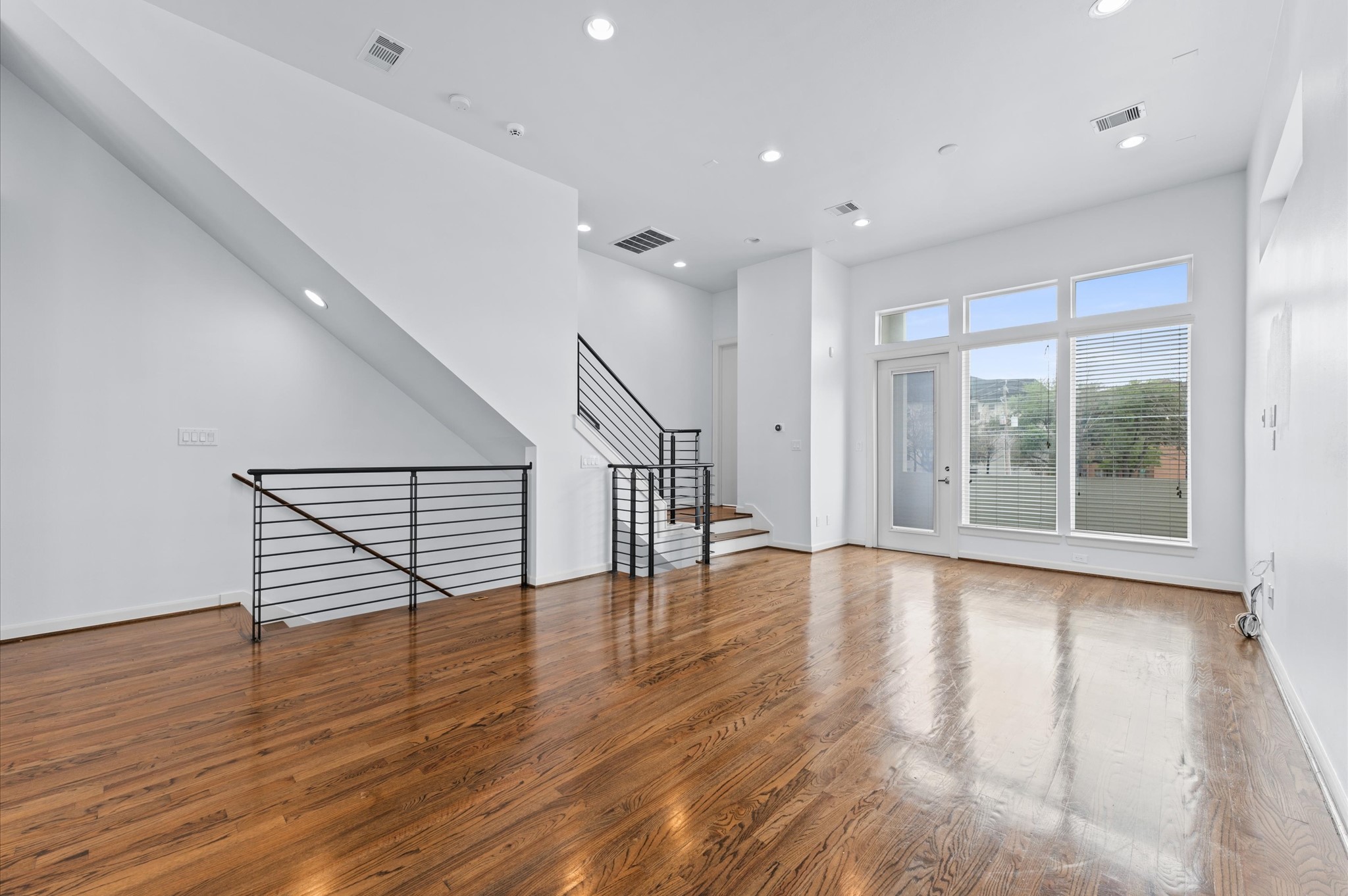 120 Pierce Street Houston, TX 77002 - Photo 20 of 45 a view of an empty room with wooden floor and a window