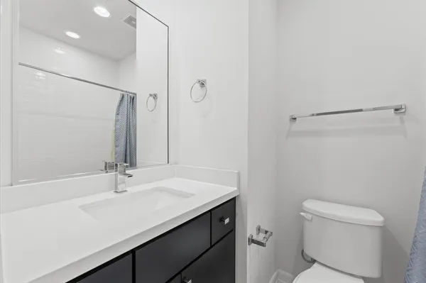 a bathroom with a tub a sink and a shower