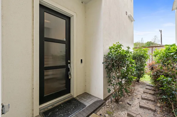 a view of a hallway with wooden floor and entryway