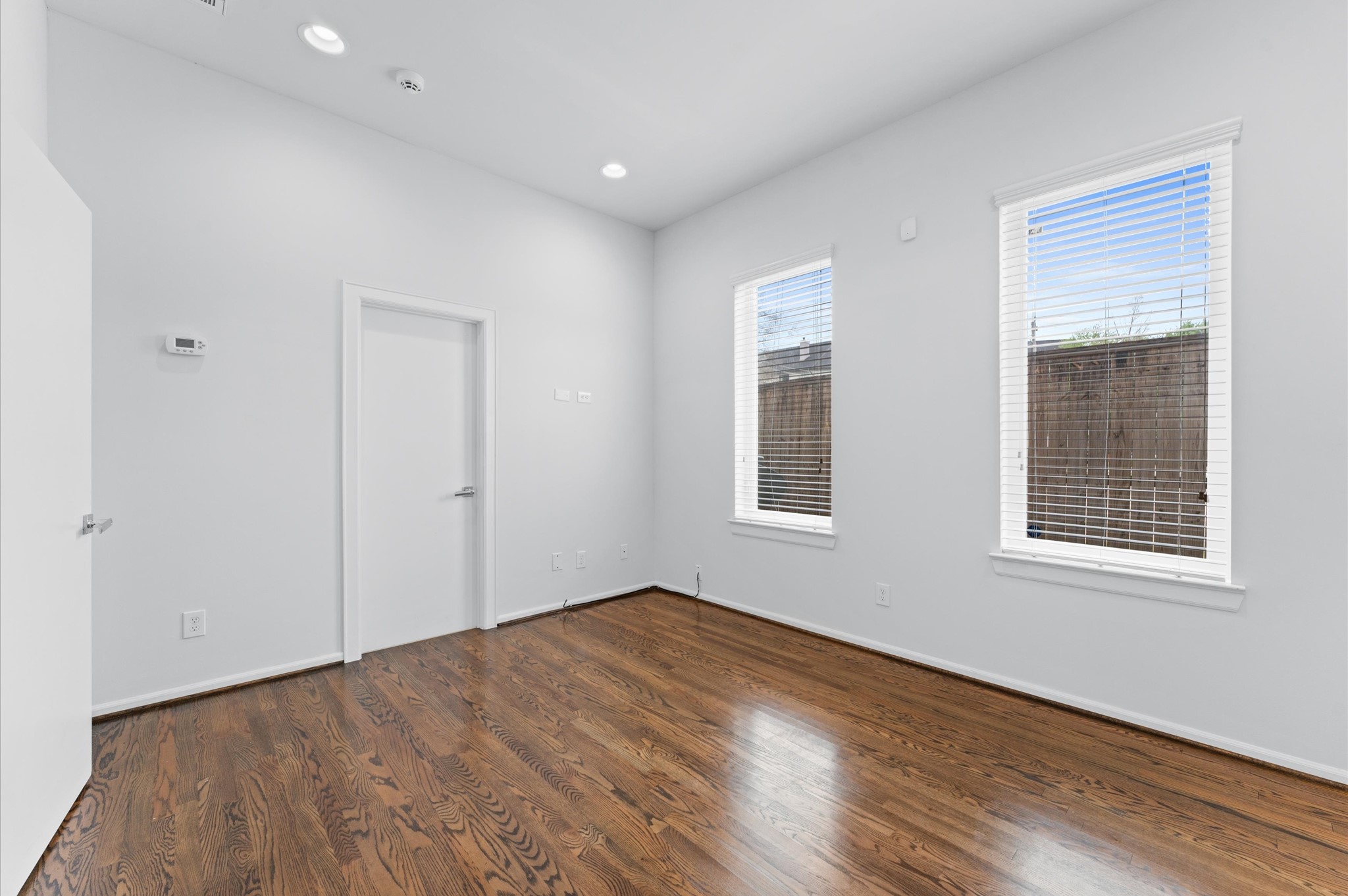 120 Pierce Street Houston, TX 77002 - Photo 8 of 45 a view of empty room with wooden floor and fan