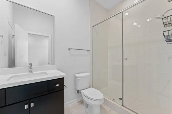 a large kitchen with granite countertop a large counter top stainless steel appliances and wooden floor