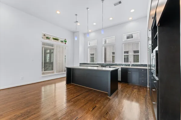 a kitchen with stainless steel appliances kitchen island wooden cabinets and granite counter tops