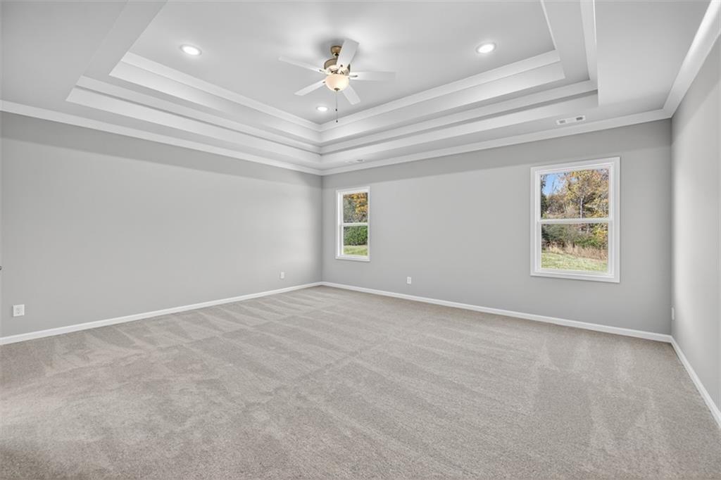 8845 Jot Em Down Road Gainesville, GA 30506 - Photo 48 of 87 en empty room with windows and ceiling fan
