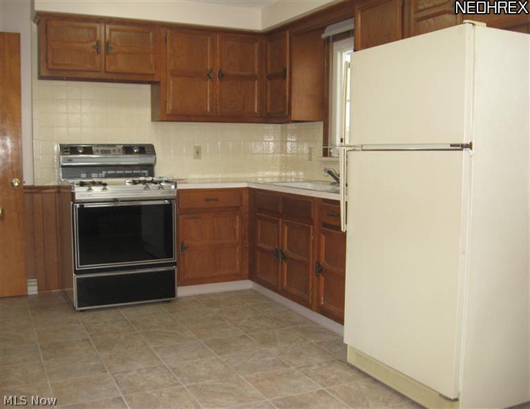 3535-3537 Birchdale Road Northwest Canton, OH 44708 - Photo 9 of 24 Kitchen features brand new vinyl floor. Appliances will remain.
