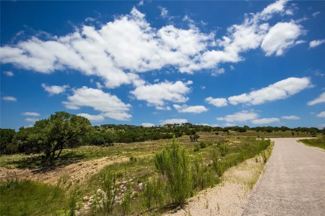 a view of a road with a building in the background