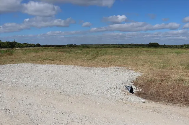 a view of a lake with sunset in background
