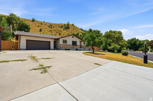1410 Sumac Drive Logan, UT 84321 - Photo 27 of 28 Ranch-style exterior with a two-car garage and a stone facade accent