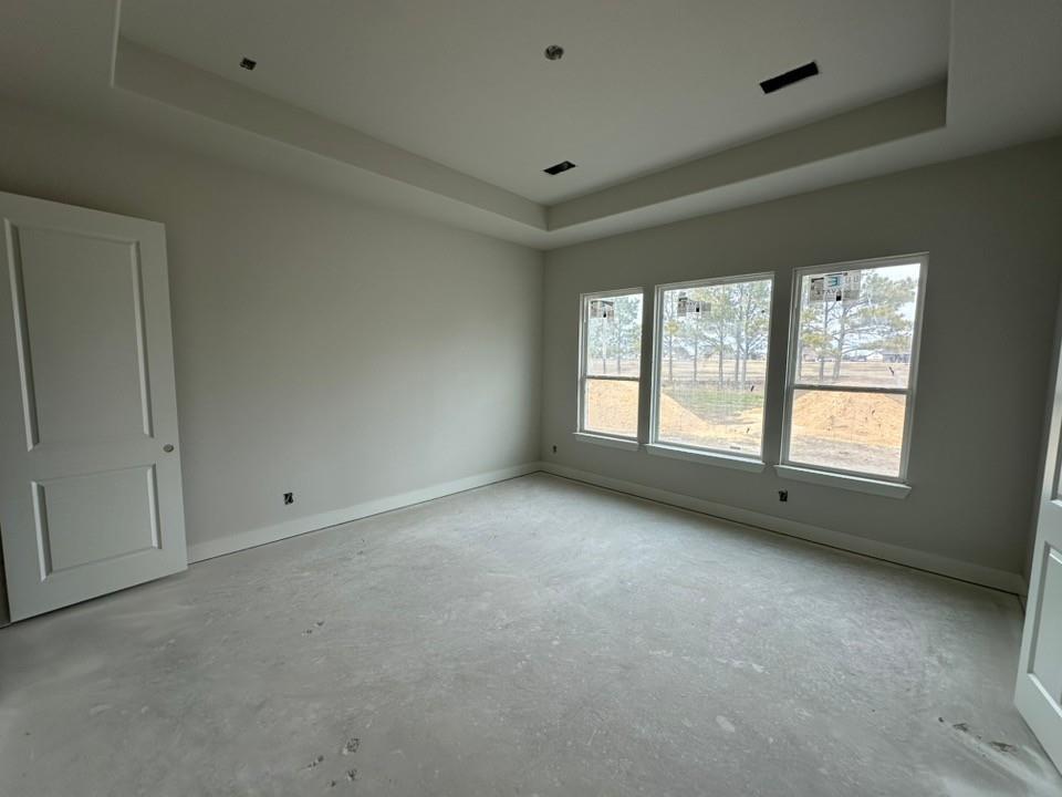 370 Cobb Road Leonard, TX 75452 - Photo 13 of 25 Empty room with a raised ceiling and unfinished concrete flooring