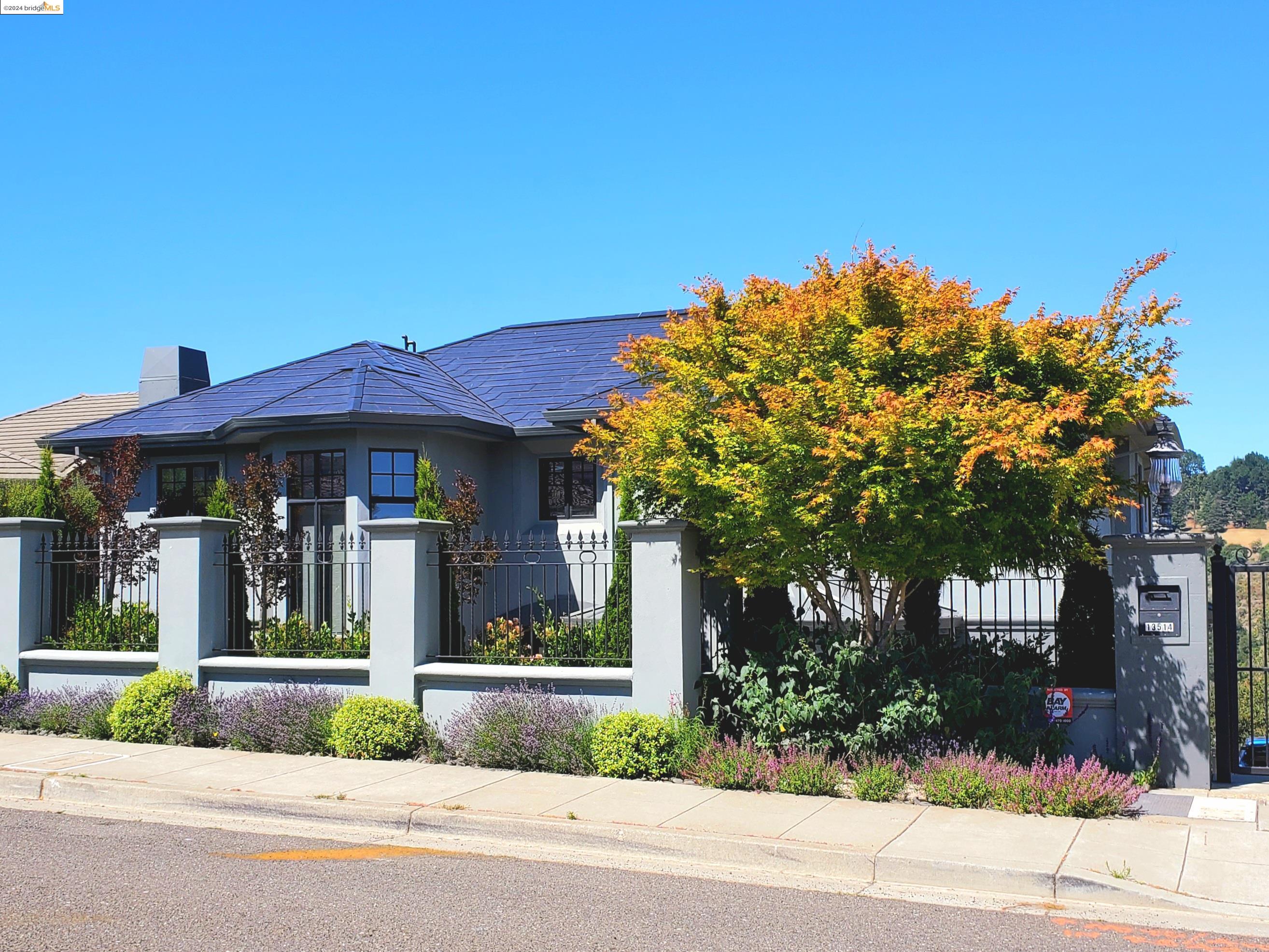 a front view of a house with a garden