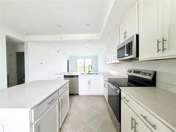 a kitchen with a sink stove and microwave