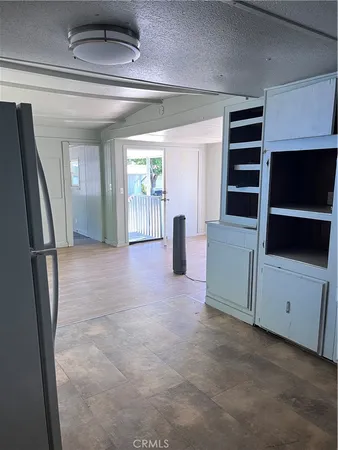 a view of livingroom with furniture and refrigerator
