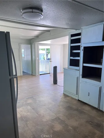 a view of livingroom with furniture and refrigerator