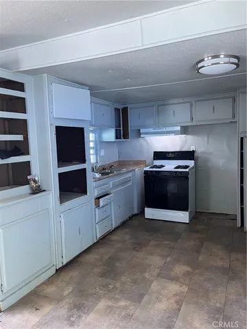 a kitchen with stainless steel appliances a stove a sink and a microwave