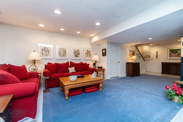 a living room with furniture and kitchen view