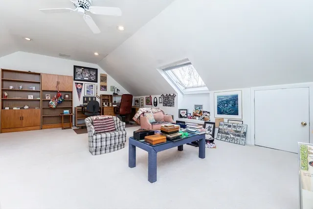 a living room with furniture and kitchen view