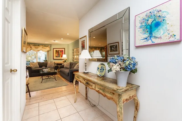 a living room with furniture and flowers