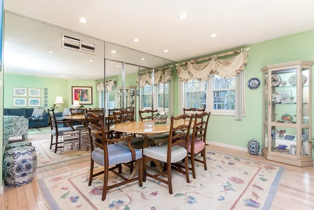 a dining room with furniture window and wooden floor