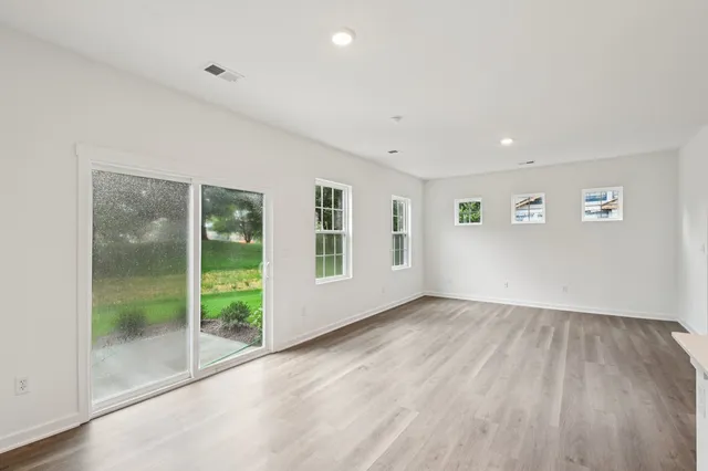 a view of an empty room and closet area