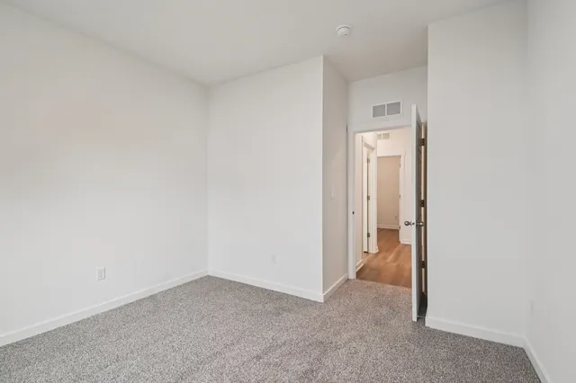 a living room with furniture a rug and a large window