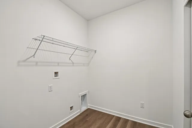 a dining room with furniture a large window and wooden floor