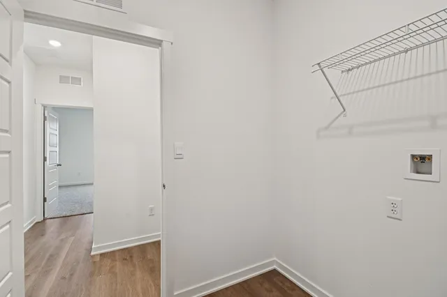 a kitchen with stainless steel appliances granite countertop a stove a sink dishwasher and a microwave with wooden floor