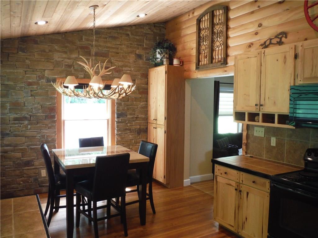 Kitchen with lots of natural light too! Features a beautiful stone wall!