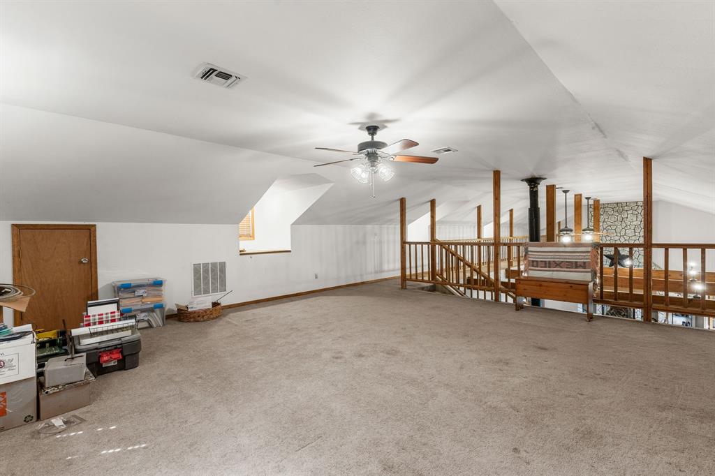 13315 Highway 281 Scotland, TX 76379 - Photo 28 of 40 Spacious carpeted loft with sloped ceiling and recessed lighting