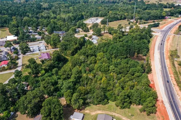 an aerial view of a house with a yard and lake view