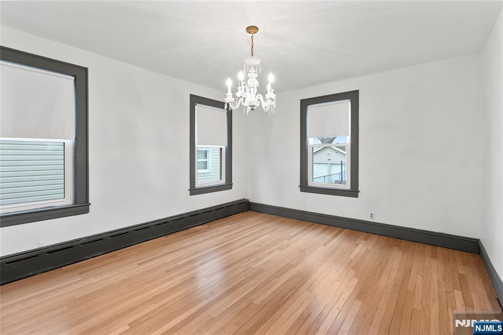 1114 Seib Avenue Elizabeth, NJ 07202 - Photo 11 of 31 a view of an empty room with wooden floor and a window