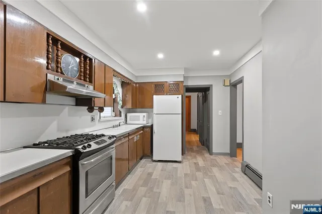 a kitchen with stainless steel appliances granite countertop a stove and a refrigerator
