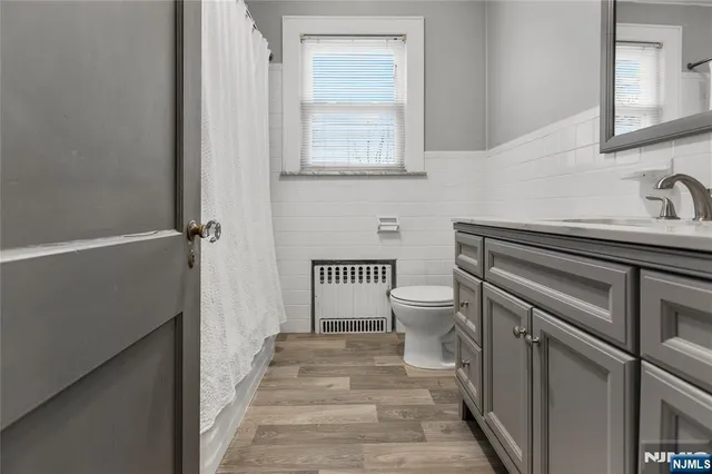 a bathroom with a sink a toilet and a mirror
