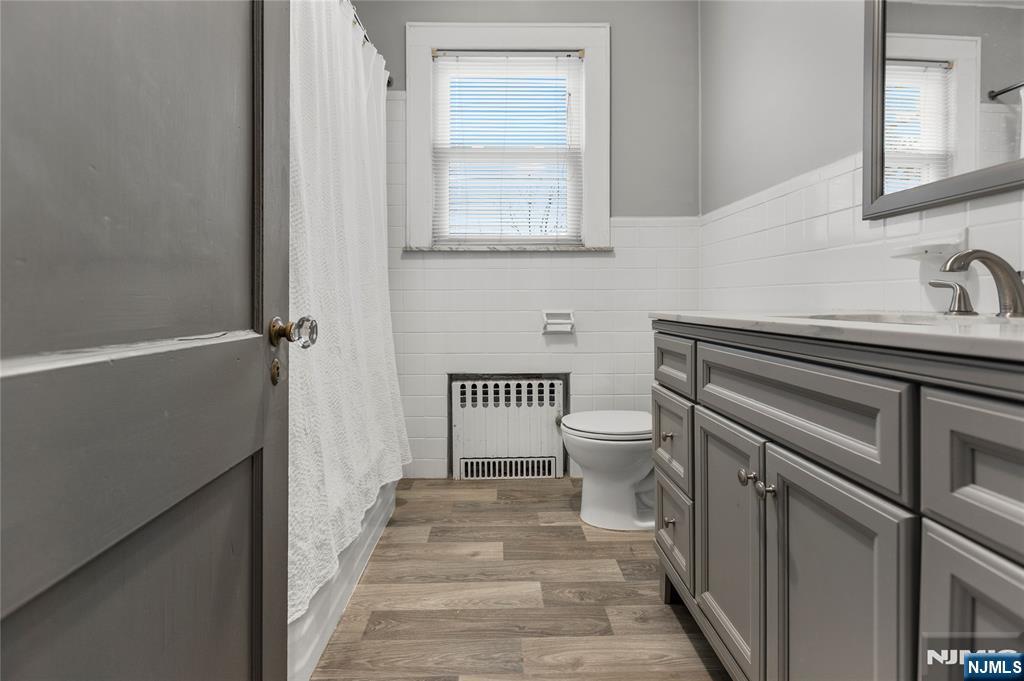 1114 Seib Avenue Elizabeth, NJ 07202 - Photo 14 of 31 a bathroom with a sink a toilet and a mirror