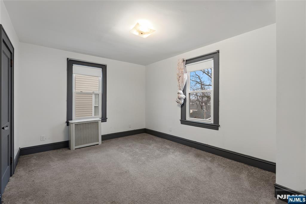 1114 Seib Avenue Elizabeth, NJ 07202 - Photo 17 of 31 an empty room with windows and closet