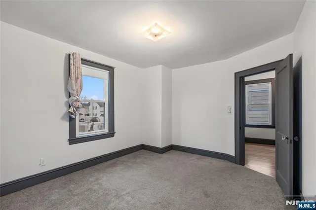 an empty room with windows and closet