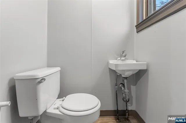 a bathroom with a sink toilet and a mirror