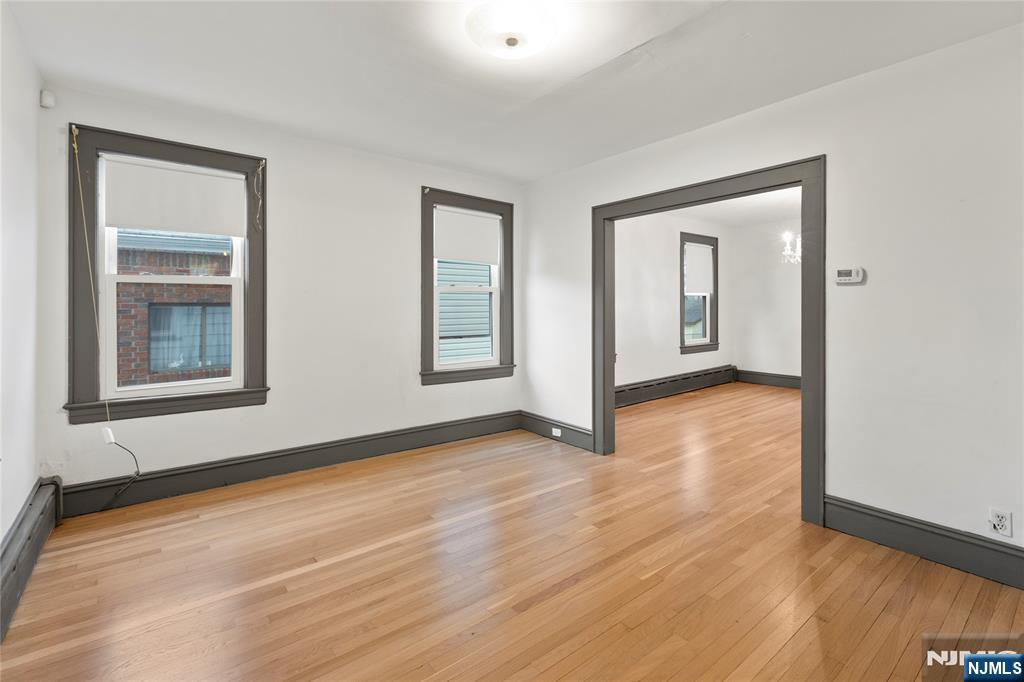 1114 Seib Avenue Elizabeth, NJ 07202 - Photo 8 of 31 a view of an empty room with wooden floor and a window