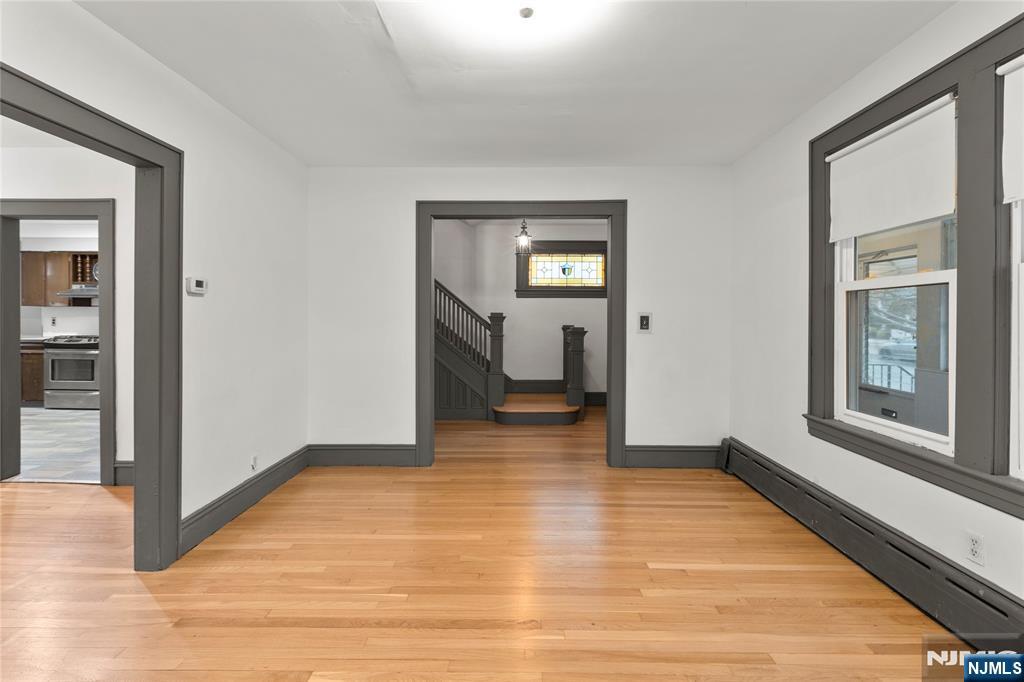1114 Seib Avenue Elizabeth, NJ 07202 - Photo 9 of 31 a view of a hallway with wooden floor and a living room