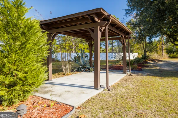 a front view of a house with swimming pool and porch with furniture