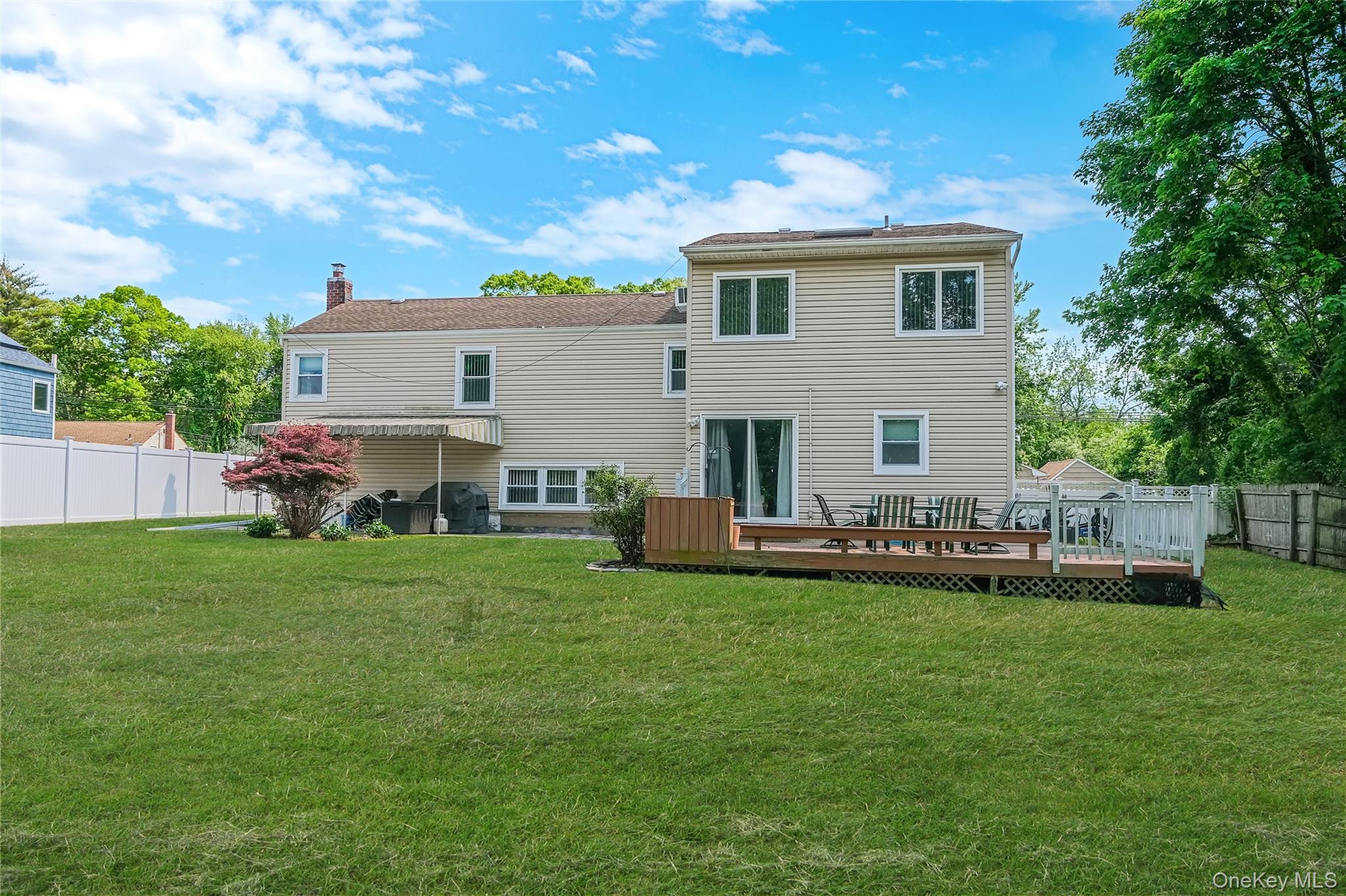 59 Maybrook Road North Babylon, NY 11703 - Photo 36 of 43 a view of a house with a yard and sitting area