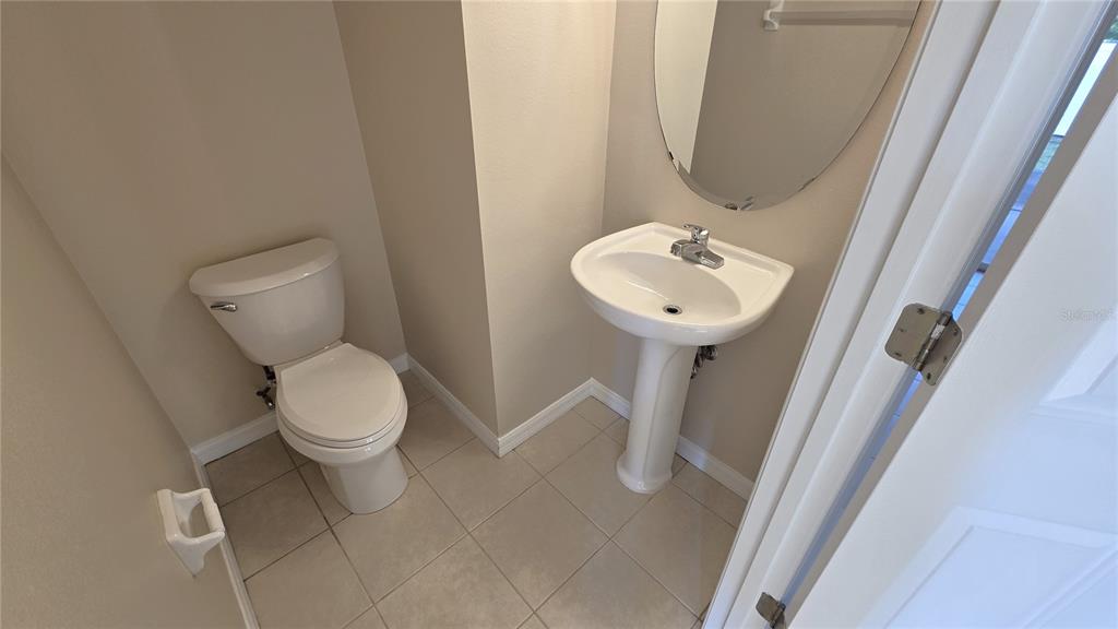 1302 Denman Court Wesley Chapel, FL 33543 - Photo 14 of 28 a white toilet sitting next to a bathroom sink