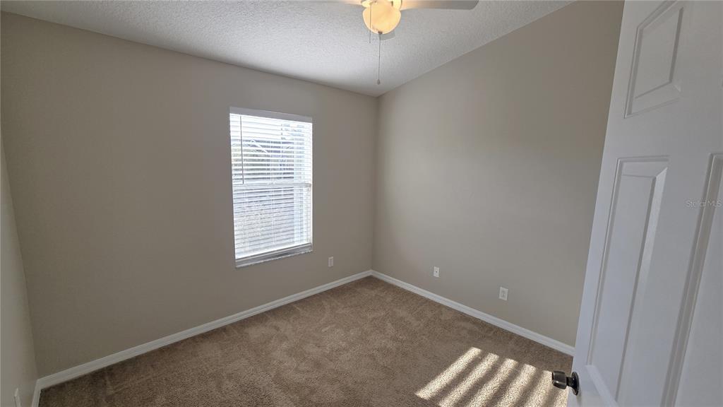 1302 Denman Court Wesley Chapel, FL 33543 - Photo 17 of 28 an empty room with windows
